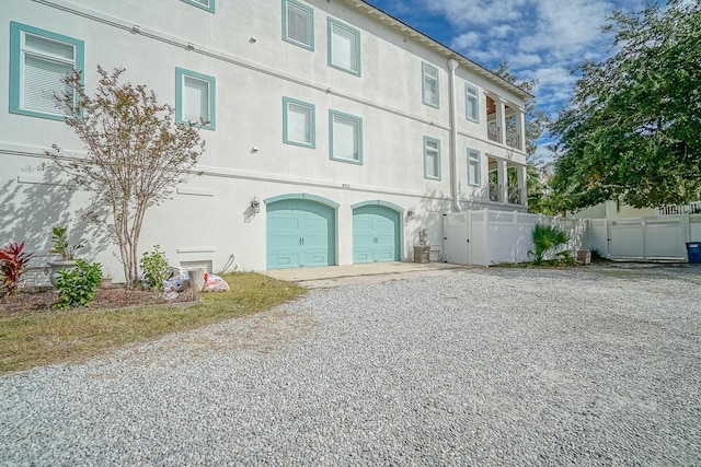 rear view of house featuring a garage