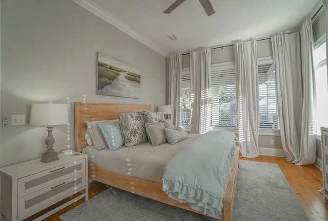 bedroom with ceiling fan, light hardwood / wood-style flooring, and crown molding