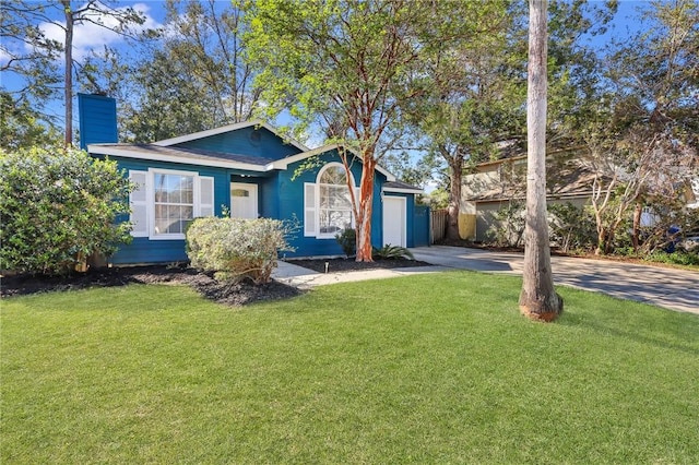 view of front of property with a garage and a front lawn