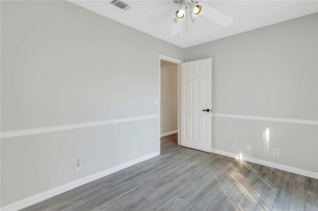 empty room featuring ceiling fan and hardwood / wood-style flooring