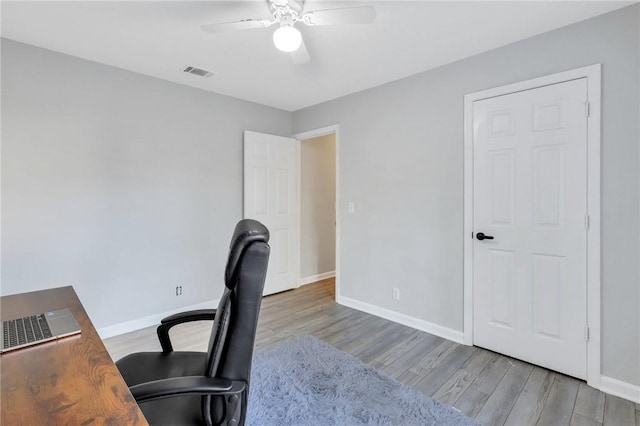 office space featuring ceiling fan and light wood-type flooring