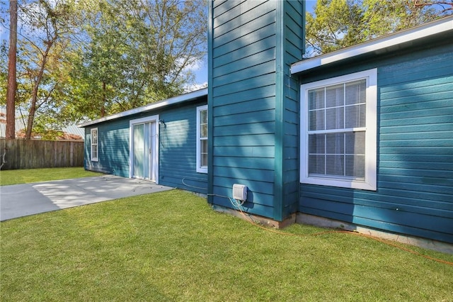 view of property exterior featuring a lawn and a patio