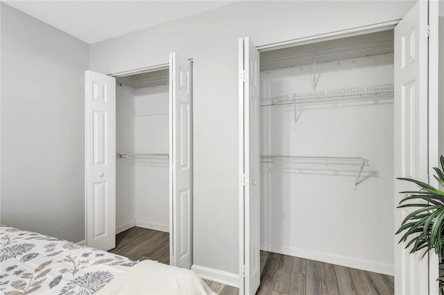 bedroom with a closet and hardwood / wood-style flooring