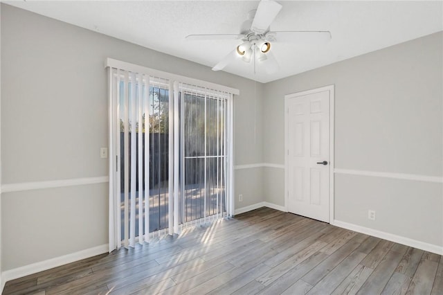 empty room with hardwood / wood-style floors and ceiling fan