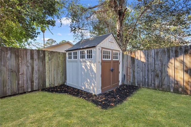 view of outbuilding featuring a lawn