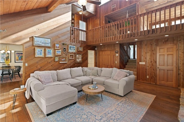 living room featuring hardwood / wood-style floors, ceiling fan, and wood walls