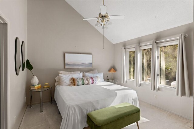 bedroom featuring light colored carpet, high vaulted ceiling, and ceiling fan