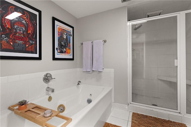 bathroom featuring tile patterned flooring and shower with separate bathtub