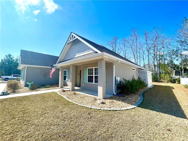 view of front of house with a patio and a front lawn