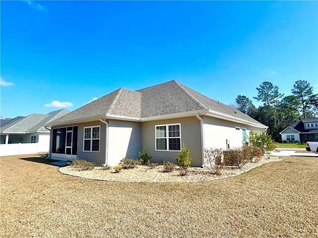 view of property exterior featuring a yard and a sunroom