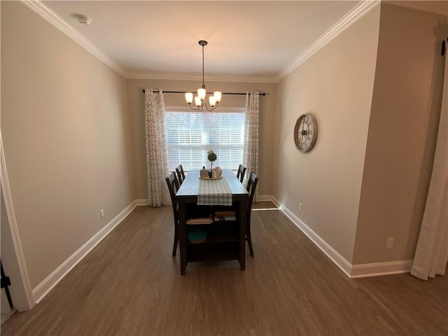 dining space with ornamental molding, dark hardwood / wood-style flooring, and a chandelier