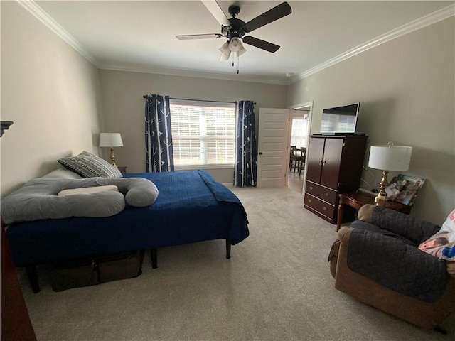 bedroom featuring ornamental molding, light colored carpet, and ceiling fan