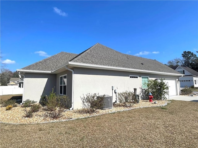 view of property exterior with central AC unit and a garage