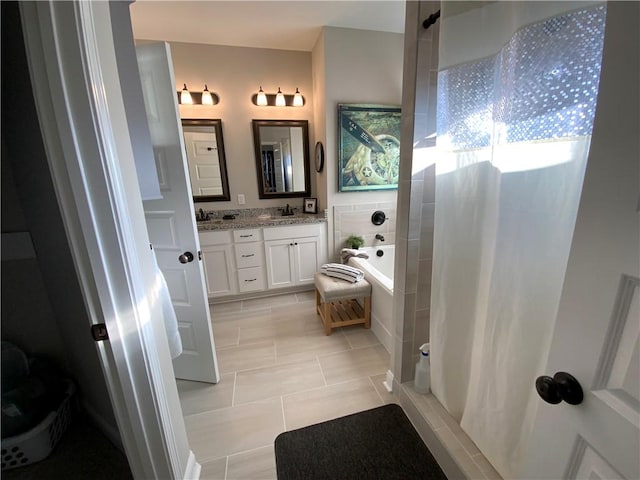 bathroom featuring independent shower and bath, vanity, and tile patterned floors