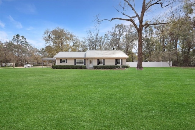 ranch-style house with fence, metal roof, and a front yard