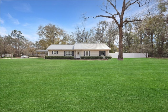 single story home featuring metal roof, a front yard, and fence