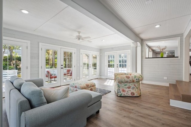 sunroom / solarium featuring french doors and a ceiling fan