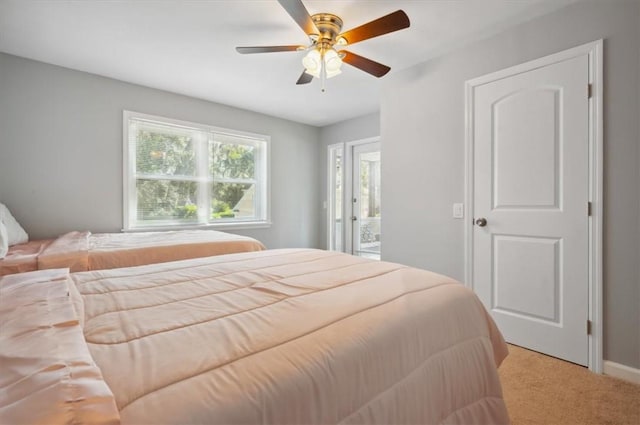 bedroom with light carpet, access to exterior, and ceiling fan