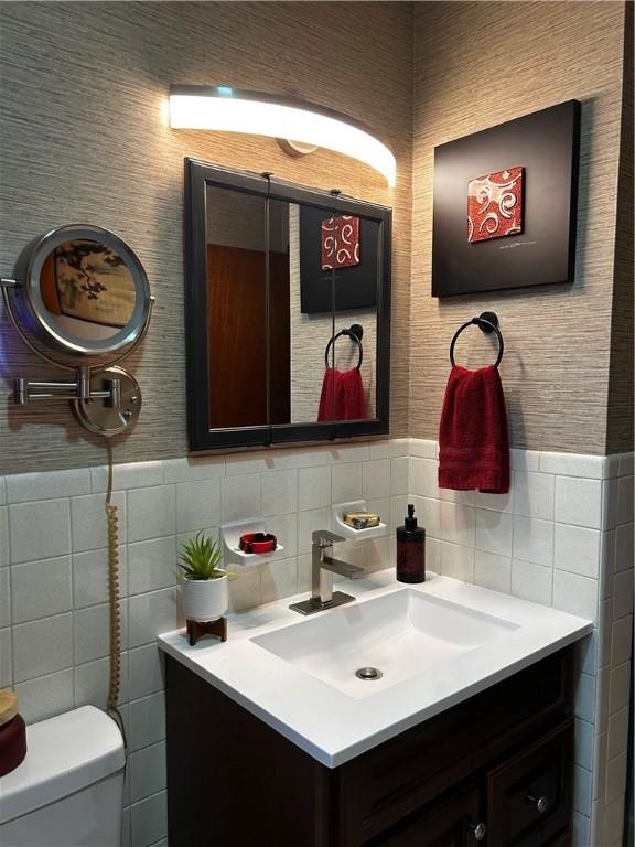 604 E Waring St, Waycross, GA 31501 - half bathroom with vanity, tile walls, and wainscoting