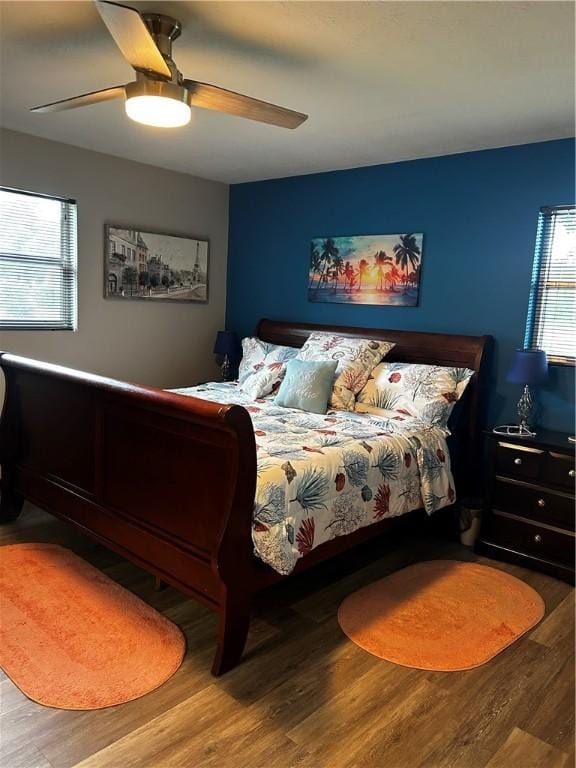 604 E Waring St, Waycross, GA 31501 - bedroom featuring multiple windows, wood finished floors, and a ceiling fan