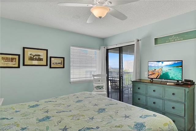 bedroom with a textured ceiling, access to outside, and ceiling fan