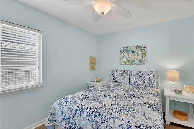 bedroom featuring hardwood / wood-style flooring and ceiling fan