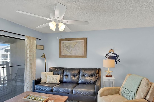 living room featuring a textured ceiling, hardwood / wood-style flooring, and ceiling fan