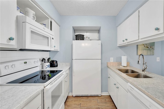 kitchen featuring white appliances, sink, light wood-type flooring, a textured ceiling, and white cabinetry