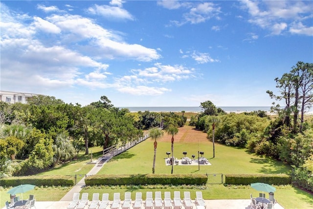 view of community featuring a water view and a lawn