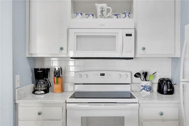 kitchen featuring white cabinets, light stone counters, white appliances, and backsplash