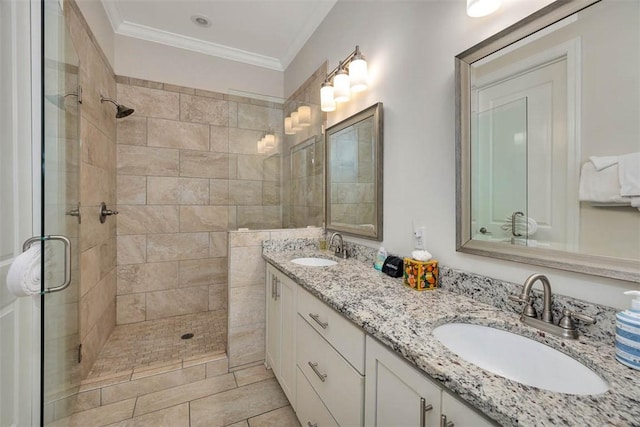 bathroom featuring a shower with shower door, ornamental molding, and vanity