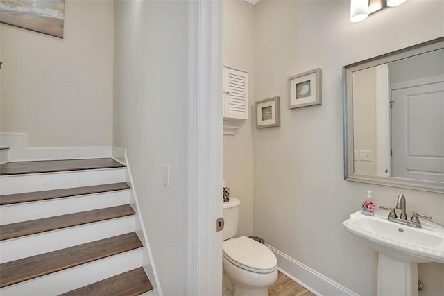 bathroom featuring sink, wood-type flooring, and toilet