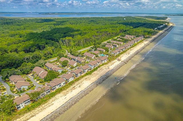 bird's eye view featuring a water view and a beach view