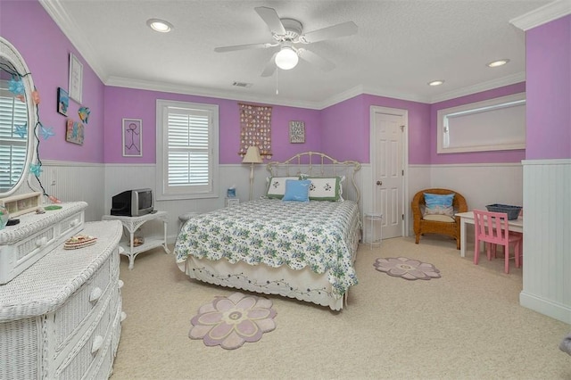 carpeted bedroom featuring visible vents, ceiling fan, recessed lighting, a textured ceiling, and a wainscoted wall