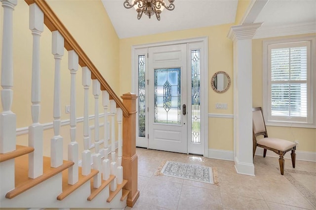 tiled entrance foyer with stairs, baseboards, and a notable chandelier