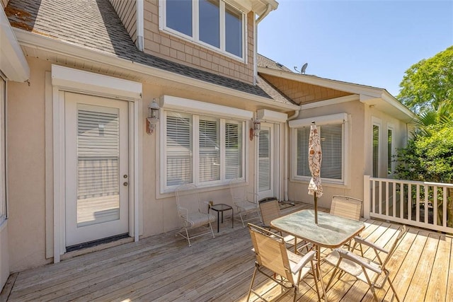 wooden deck featuring outdoor dining area