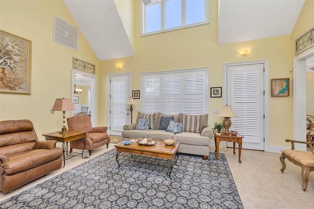 living room featuring visible vents, baseboards, and high vaulted ceiling