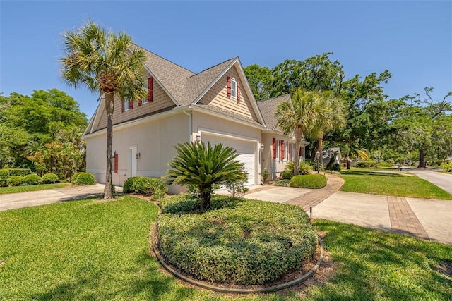 view of side of home with a yard, driveway, and a garage