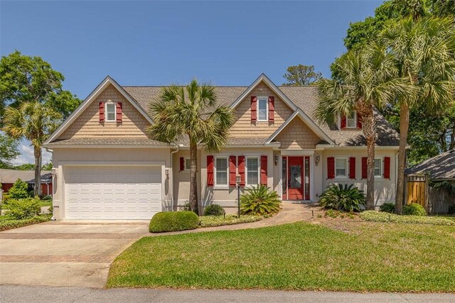 view of front of property featuring a garage, fence, a front lawn, concrete driveway, and stucco siding