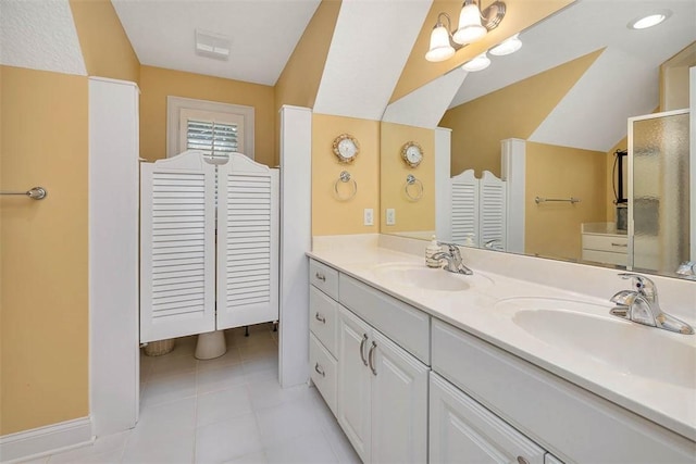 full bathroom featuring double vanity, a sink, tile patterned flooring, and a closet