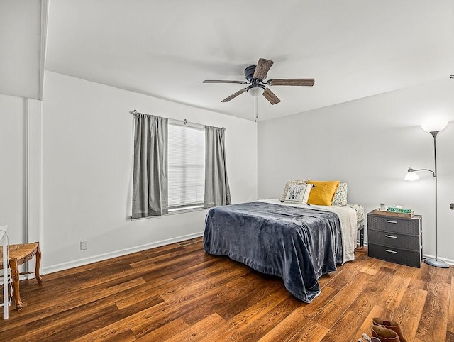 bedroom with dark wood-type flooring and ceiling fan