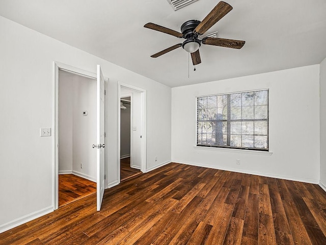 unfurnished bedroom with dark wood-type flooring, ceiling fan, and a closet