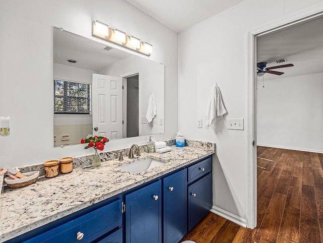 bathroom featuring vanity, wood-type flooring, and ceiling fan