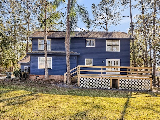 back of house featuring a wooden deck and a lawn