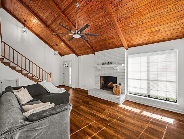 living room with ceiling fan, beam ceiling, dark hardwood / wood-style floors, a fireplace, and wooden ceiling