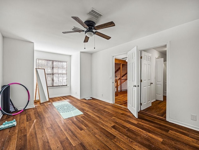 interior space with ceiling fan and dark hardwood / wood-style flooring