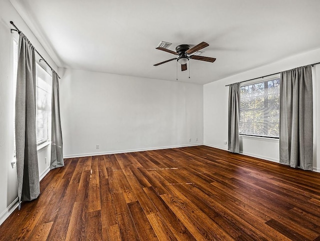 spare room featuring dark hardwood / wood-style flooring, plenty of natural light, and ceiling fan