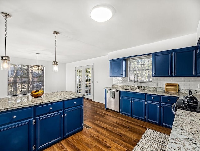 kitchen featuring pendant lighting, stainless steel dishwasher, blue cabinets, and sink