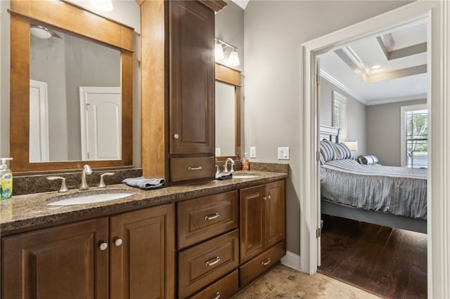 full bath with double vanity, a sink, connected bathroom, and crown molding