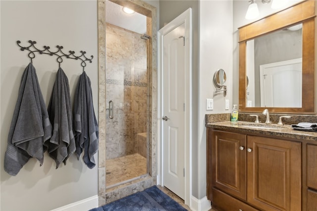 full bath featuring a stall shower and vanity